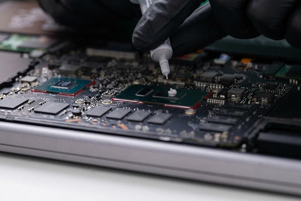 Wärmeleitpaste wird auf den Prozessor eines Laptops aufgetragen